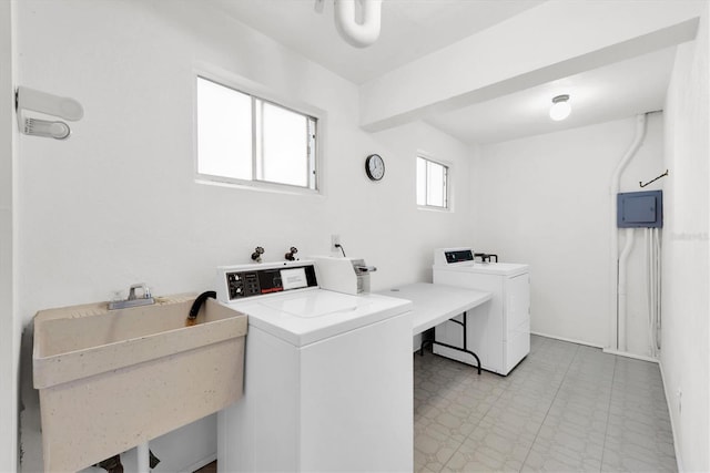 laundry area with independent washer and dryer and sink