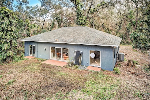 back of property with cooling unit and a patio area