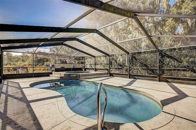 view of pool with a patio area, a lanai, and an in ground hot tub