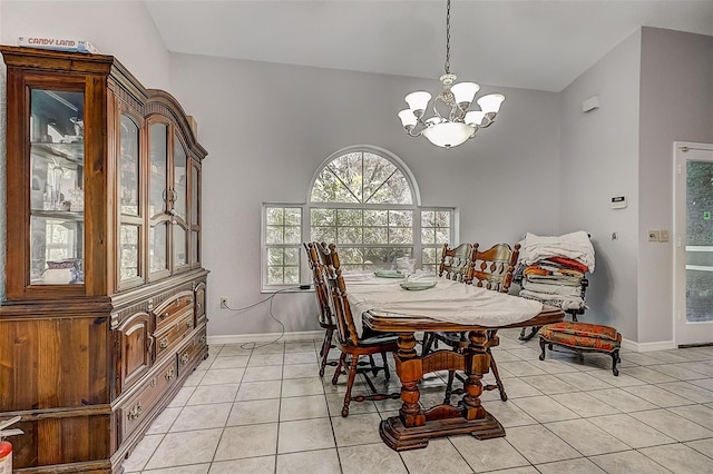 dining area with a chandelier, light tile patterned floors, and vaulted ceiling