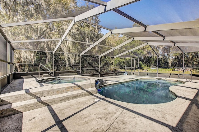 view of pool with a patio, a lanai, and an in ground hot tub