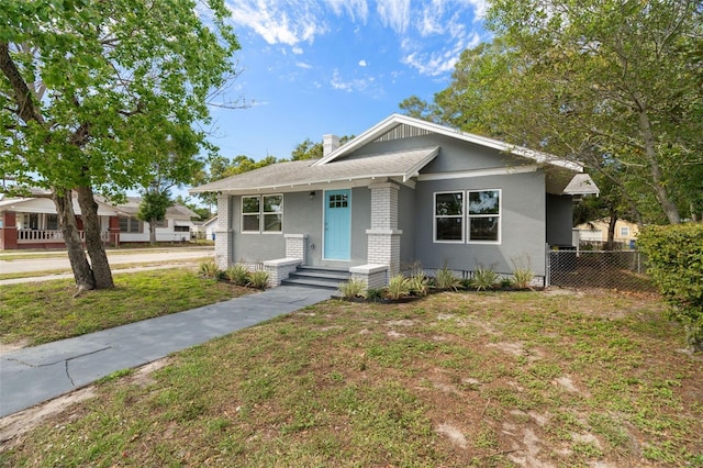 bungalow with a front lawn