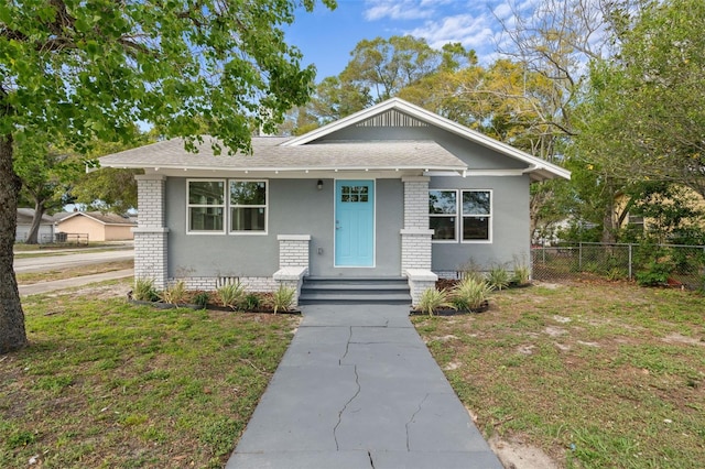 bungalow-style home featuring a front lawn