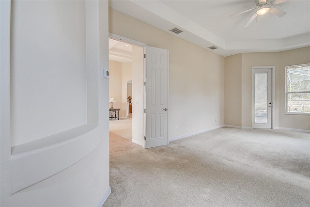 carpeted spare room featuring ceiling fan