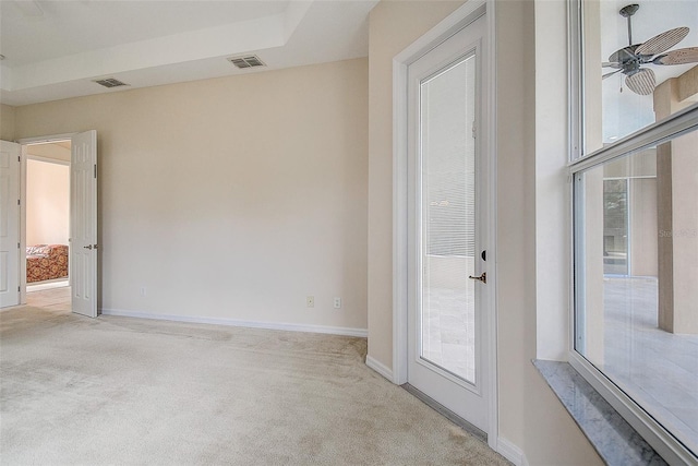 carpeted spare room featuring ceiling fan