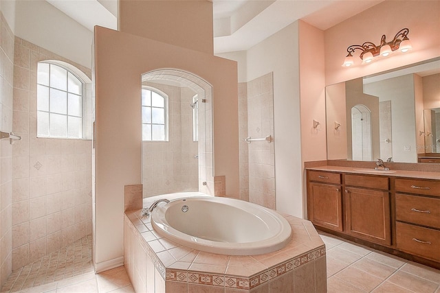 bathroom with shower with separate bathtub, vanity, and tile patterned floors