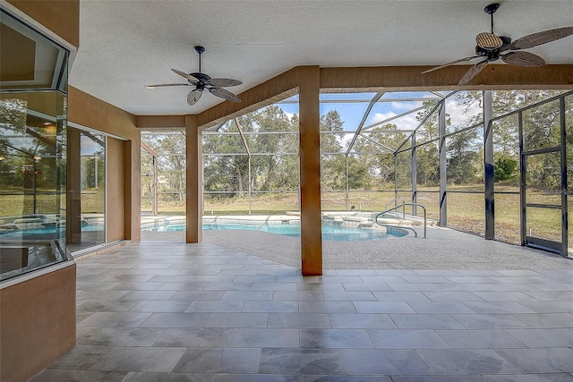 view of pool featuring a lanai, ceiling fan, and a patio area