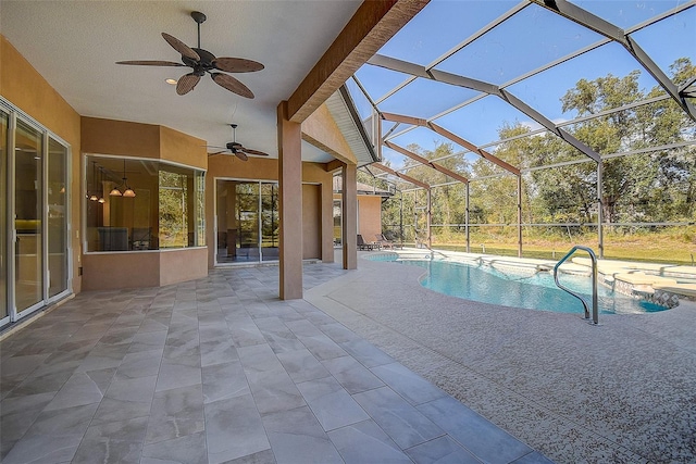 view of pool with ceiling fan, a lanai, and a patio area