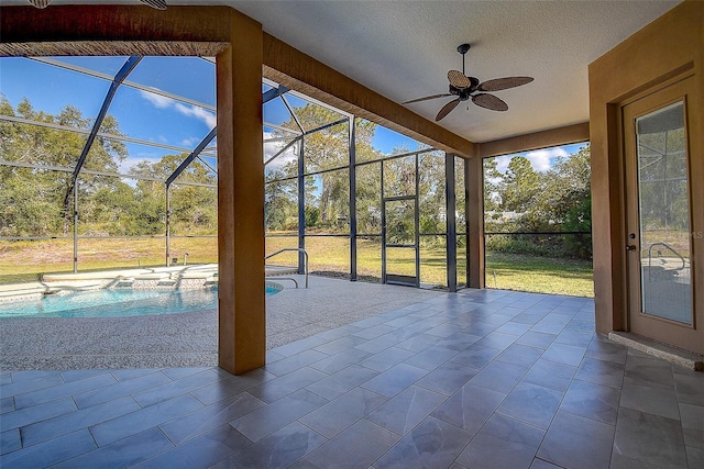 unfurnished sunroom with ceiling fan and a pool