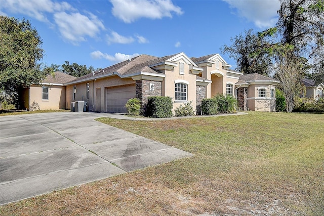 view of front of house featuring a garage, central AC unit, and a front yard