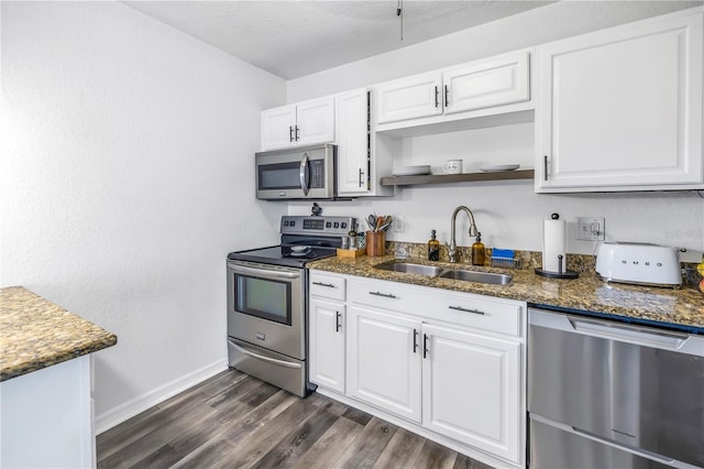 kitchen with dark hardwood / wood-style flooring, white cabinetry, appliances with stainless steel finishes, and sink