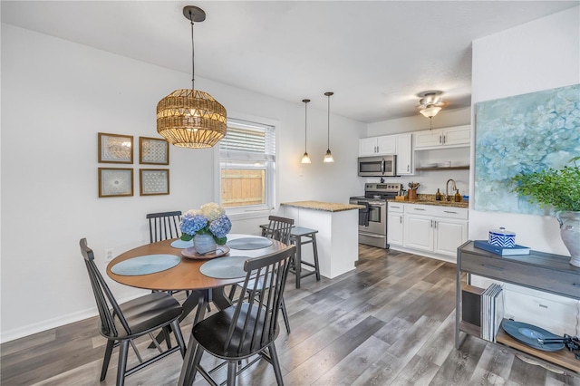 dining area with sink and dark hardwood / wood-style flooring