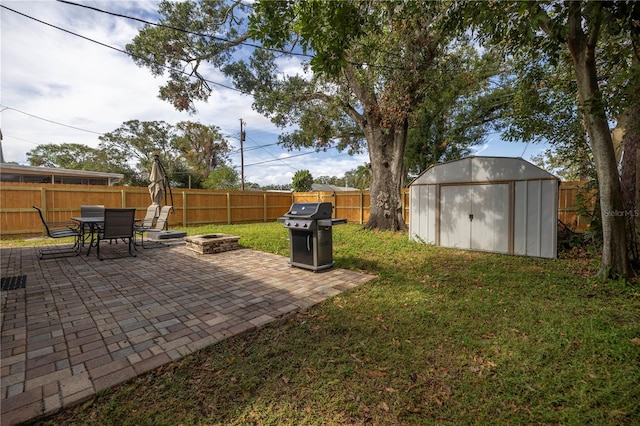 view of yard with a patio area, an outdoor fire pit, and a shed