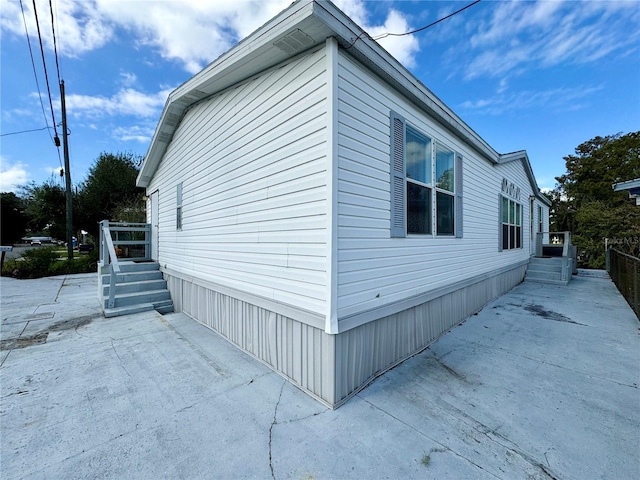 view of side of property featuring a patio area