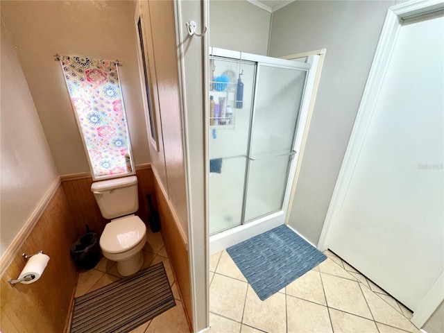 bathroom with toilet, an enclosed shower, wooden walls, and tile patterned flooring