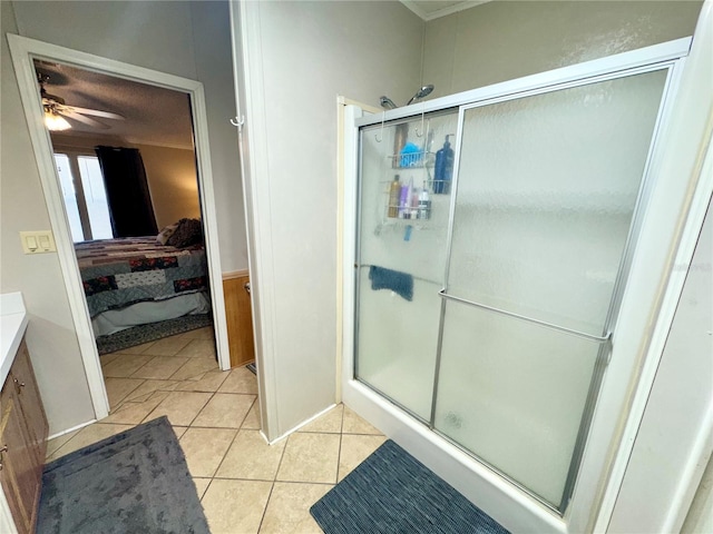 bathroom featuring ceiling fan, vanity, tile patterned floors, and a shower with door