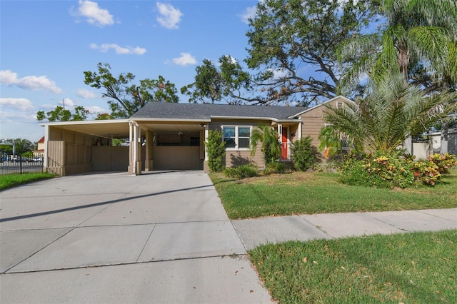 view of front facade featuring a front lawn and a carport