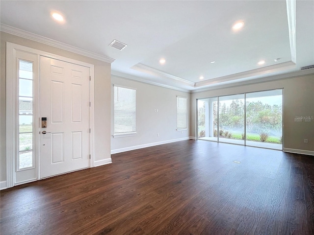 entrance foyer with dark wood-type flooring, a healthy amount of sunlight, and ornamental molding