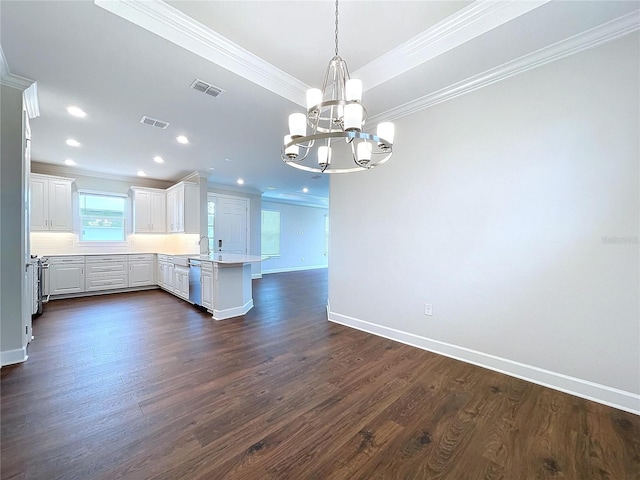 kitchen with pendant lighting, crown molding, stainless steel dishwasher, dark hardwood / wood-style flooring, and white cabinetry