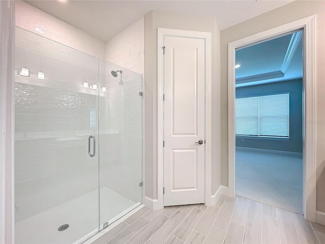 bathroom with a shower with door