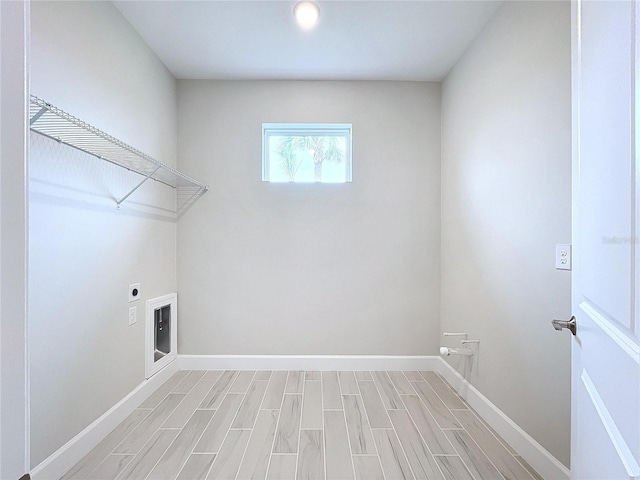 washroom featuring light wood-type flooring and hookup for an electric dryer