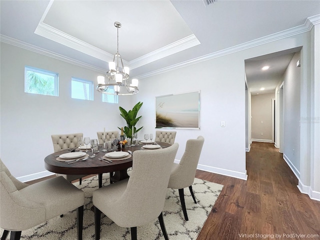 dining area with dark hardwood / wood-style flooring, a raised ceiling, and ornamental molding