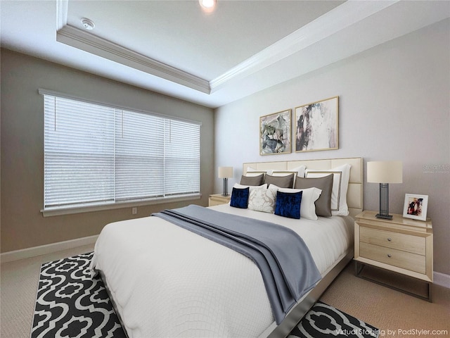 bedroom with carpet flooring, a raised ceiling, and ornamental molding