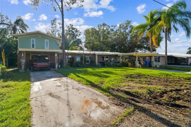 view of front of home with a front lawn and a carport