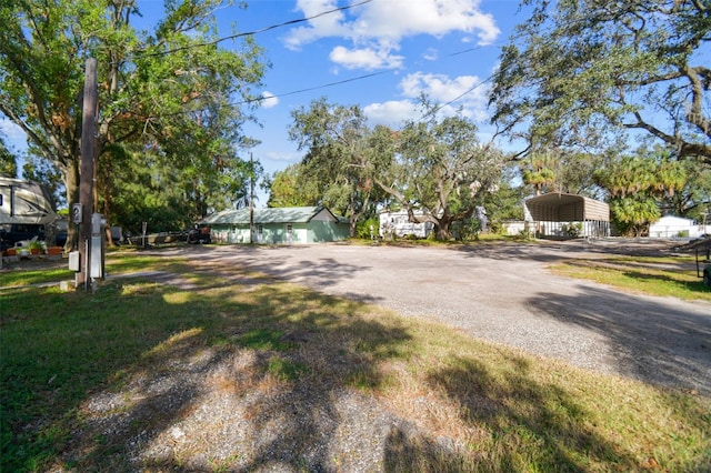 exterior space featuring a front lawn and a carport