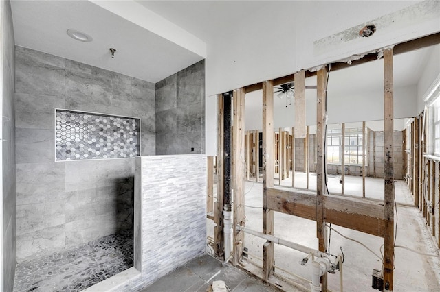 bathroom featuring tile walls and ceiling fan