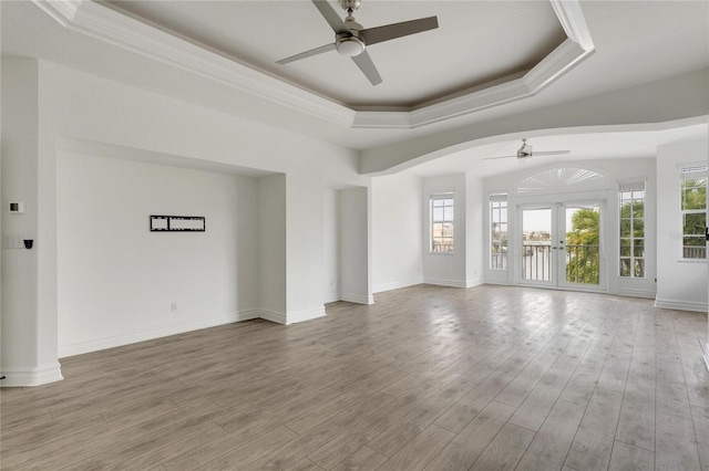 unfurnished room featuring french doors, wood-type flooring, ceiling fan, and a tray ceiling