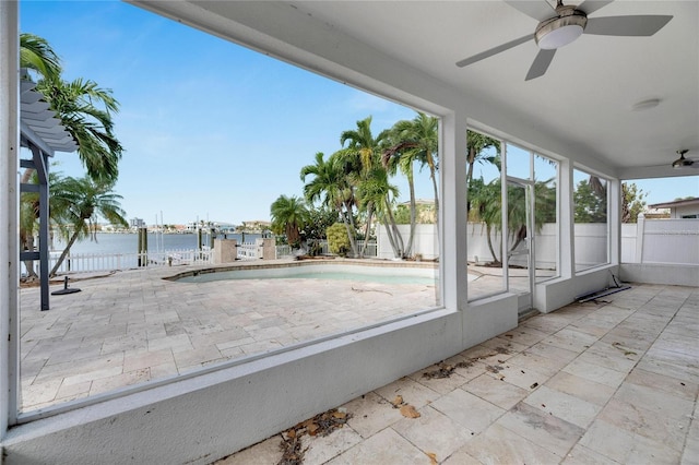 exterior space featuring a water view, a pool with hot tub, and ceiling fan