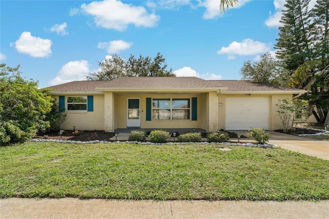 single story home featuring a front lawn and a garage