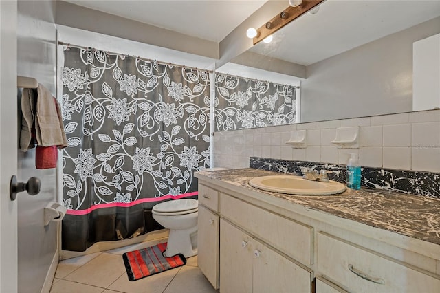 bathroom with tile patterned flooring, vanity, backsplash, and toilet