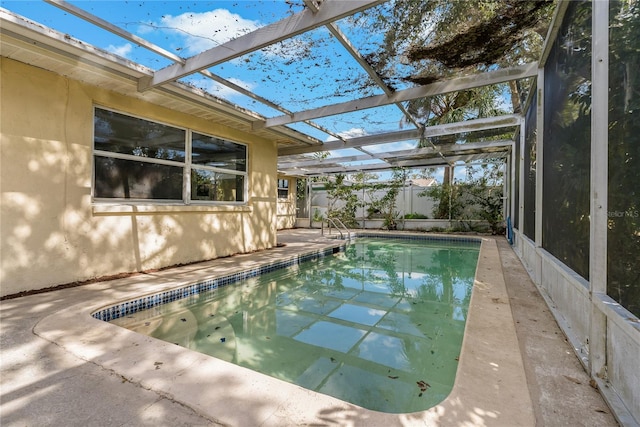 view of swimming pool with a patio and a lanai