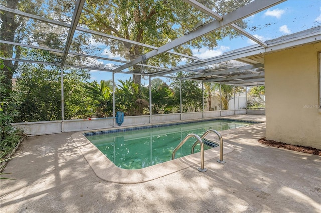 view of pool featuring a patio and glass enclosure