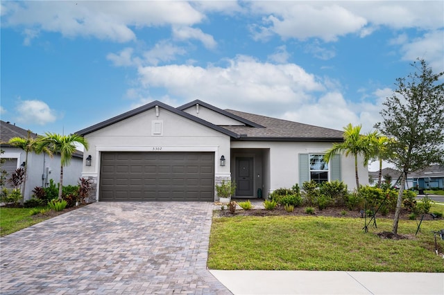 single story home featuring a garage and a front lawn