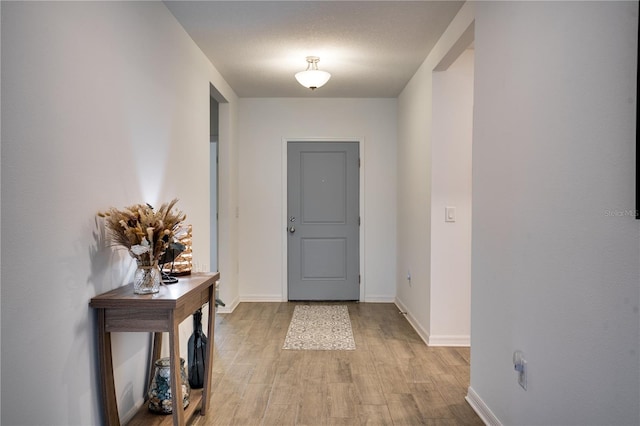 interior space featuring light hardwood / wood-style floors and a textured ceiling