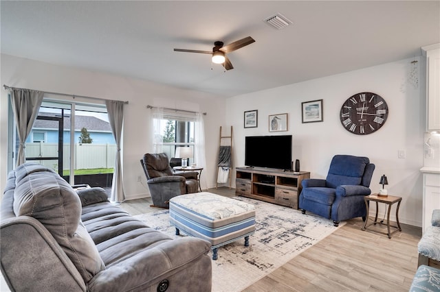 living room featuring light wood-type flooring and ceiling fan