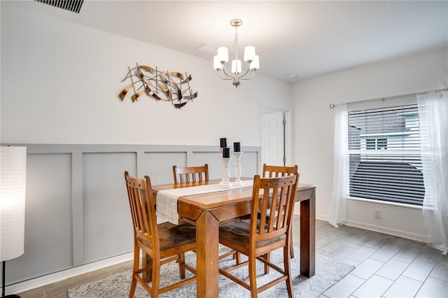 dining room with a notable chandelier and light hardwood / wood-style floors