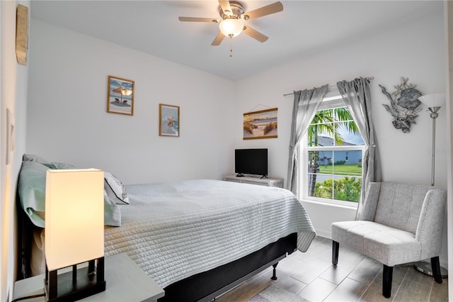 bedroom with light hardwood / wood-style flooring and ceiling fan