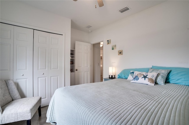 bedroom featuring ceiling fan, a closet, and wood-type flooring