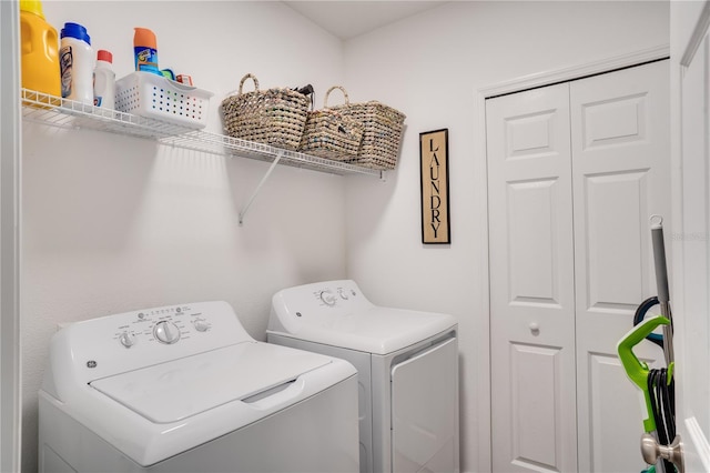 clothes washing area with washing machine and clothes dryer