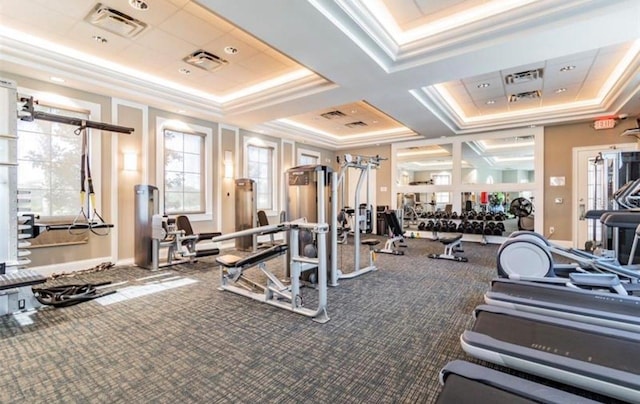 exercise room with carpet, crown molding, and coffered ceiling