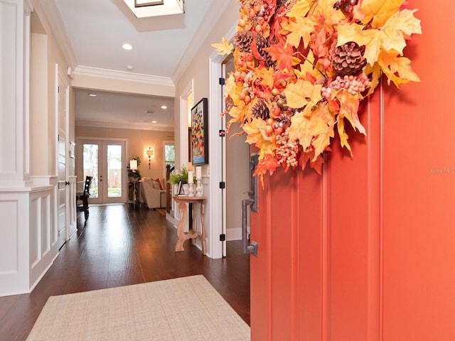 foyer entrance with dark wood-type flooring, french doors, and crown molding