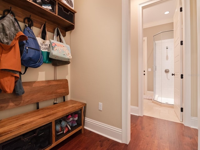 mudroom featuring ornamental molding, dark wood-type flooring, recessed lighting, and baseboards