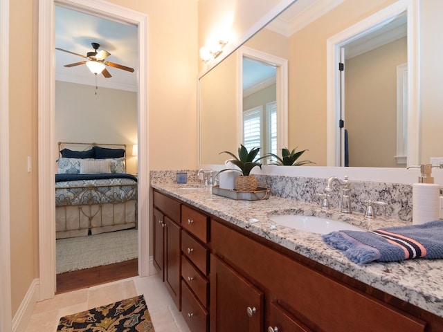 bathroom with ensuite bathroom, double vanity, ornamental molding, and a sink