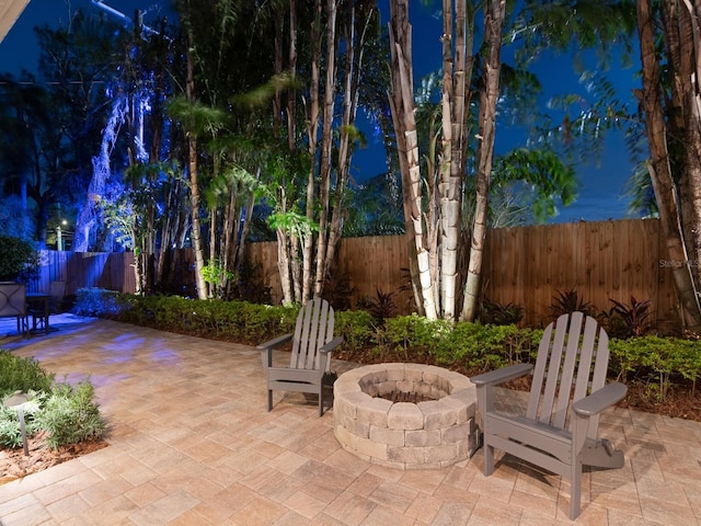 view of patio featuring an outdoor fire pit and a fenced backyard