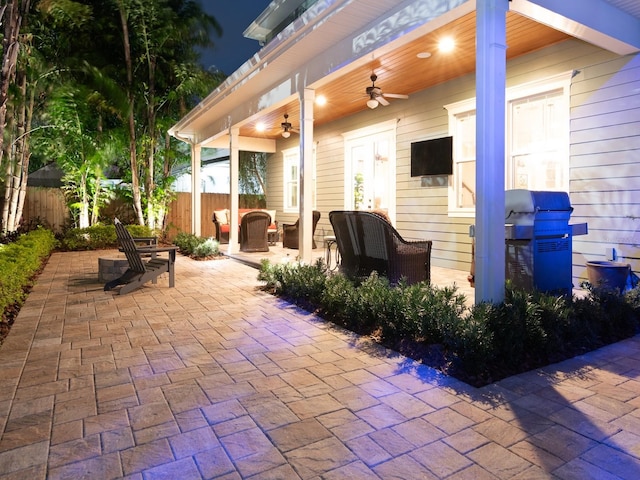 view of patio / terrace with fence and a ceiling fan