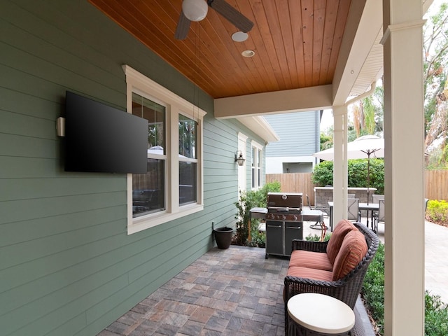 view of patio / terrace with a ceiling fan, outdoor dining space, and fence